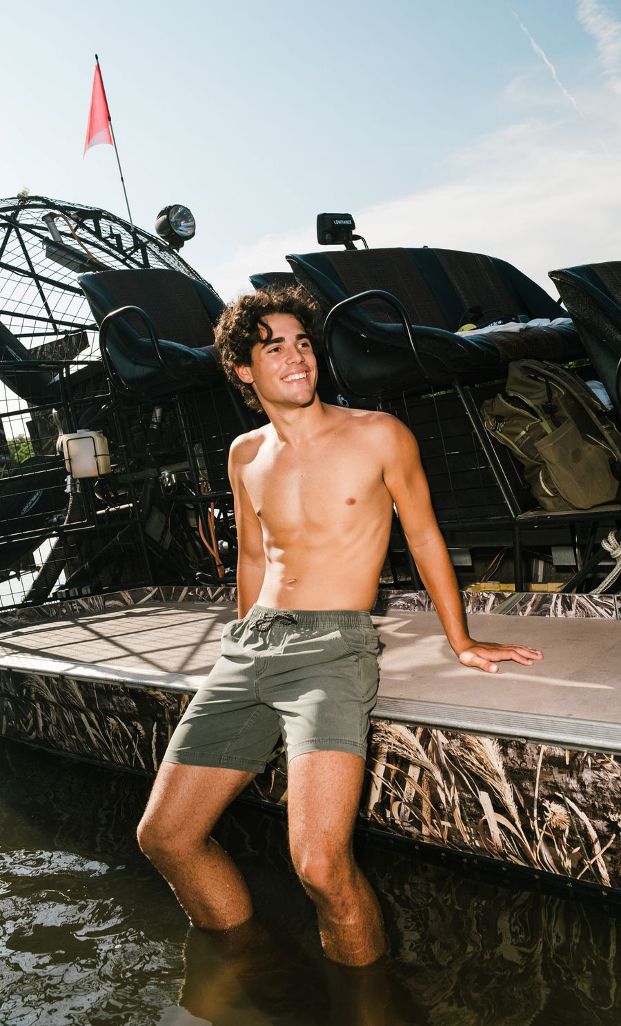 Man on boat wearing Volley Short in Green