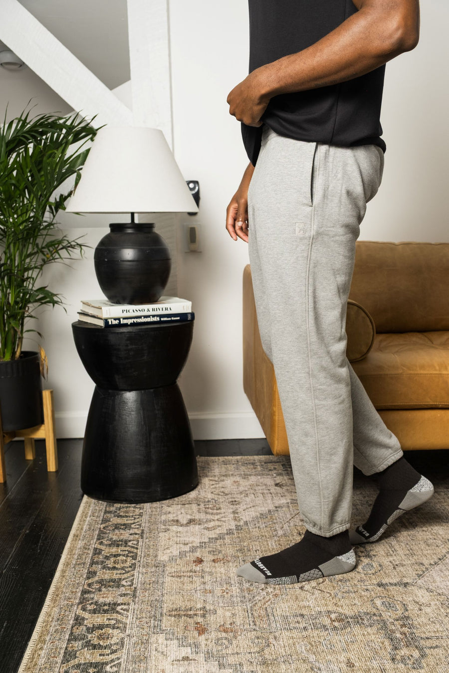 Person wearing Core Jogger in Heather Grey and Supima Tee in Black