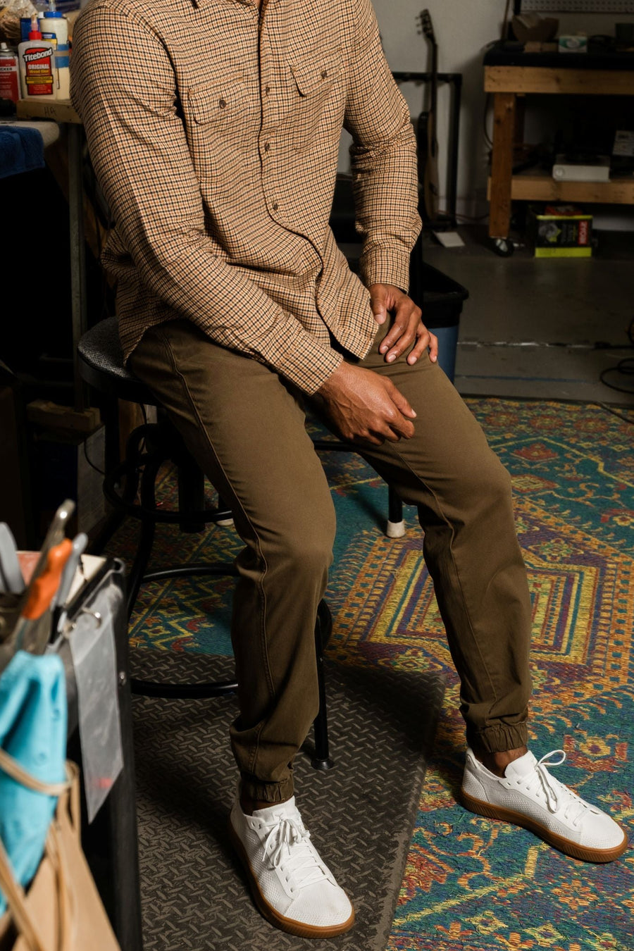 Man sitting on a stool wearing Stretch Jogger in Desert and Everyday Flannel Shirt in Camel/Black in a workshop