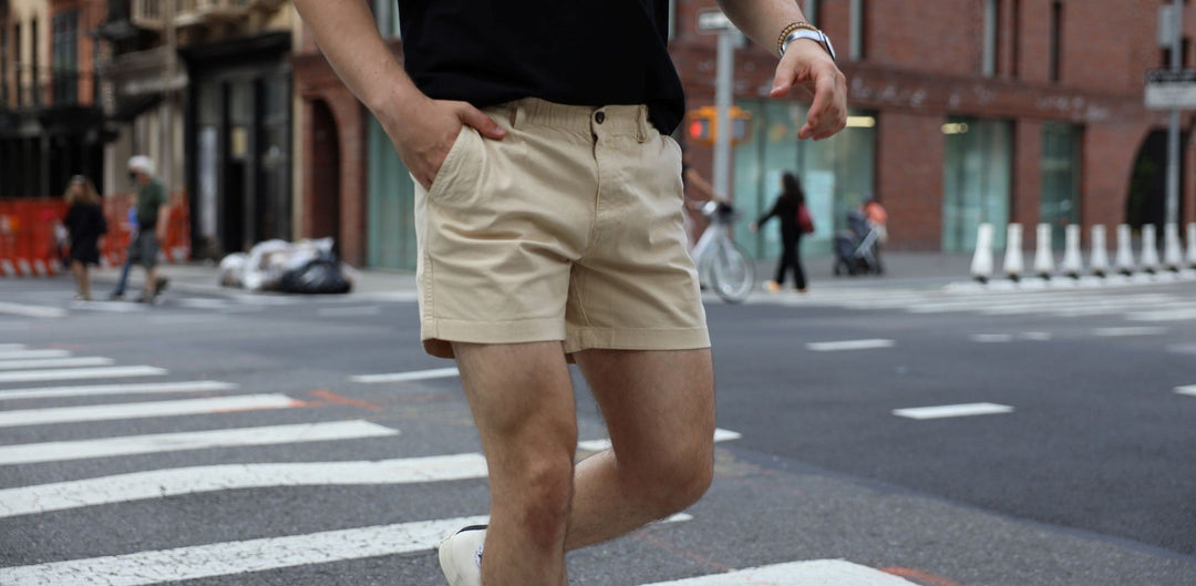Man crossing city street wearing Stretch Short in Sand Dune