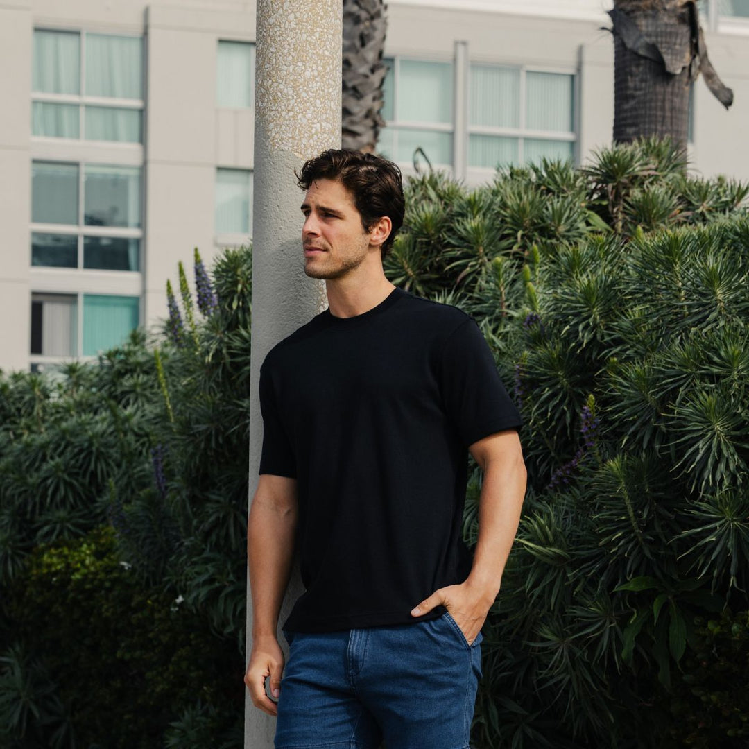 Man wearing Midweight Supima Tee in Black and Stretch Denim Short in Dark Wash