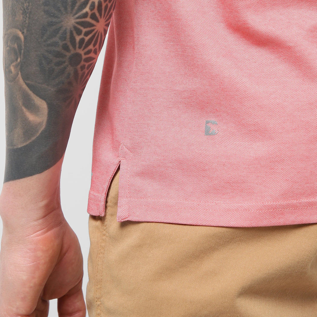 Range Polo Coral close up of Bearbottom B logo and split hem