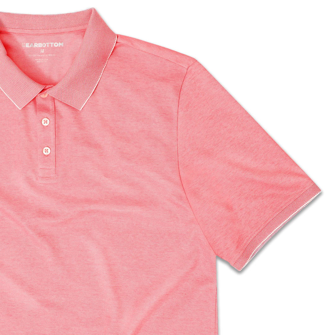 Range Polo Coral front close up with ribbed collar, ribbed short sleeves, and 3 white buttons