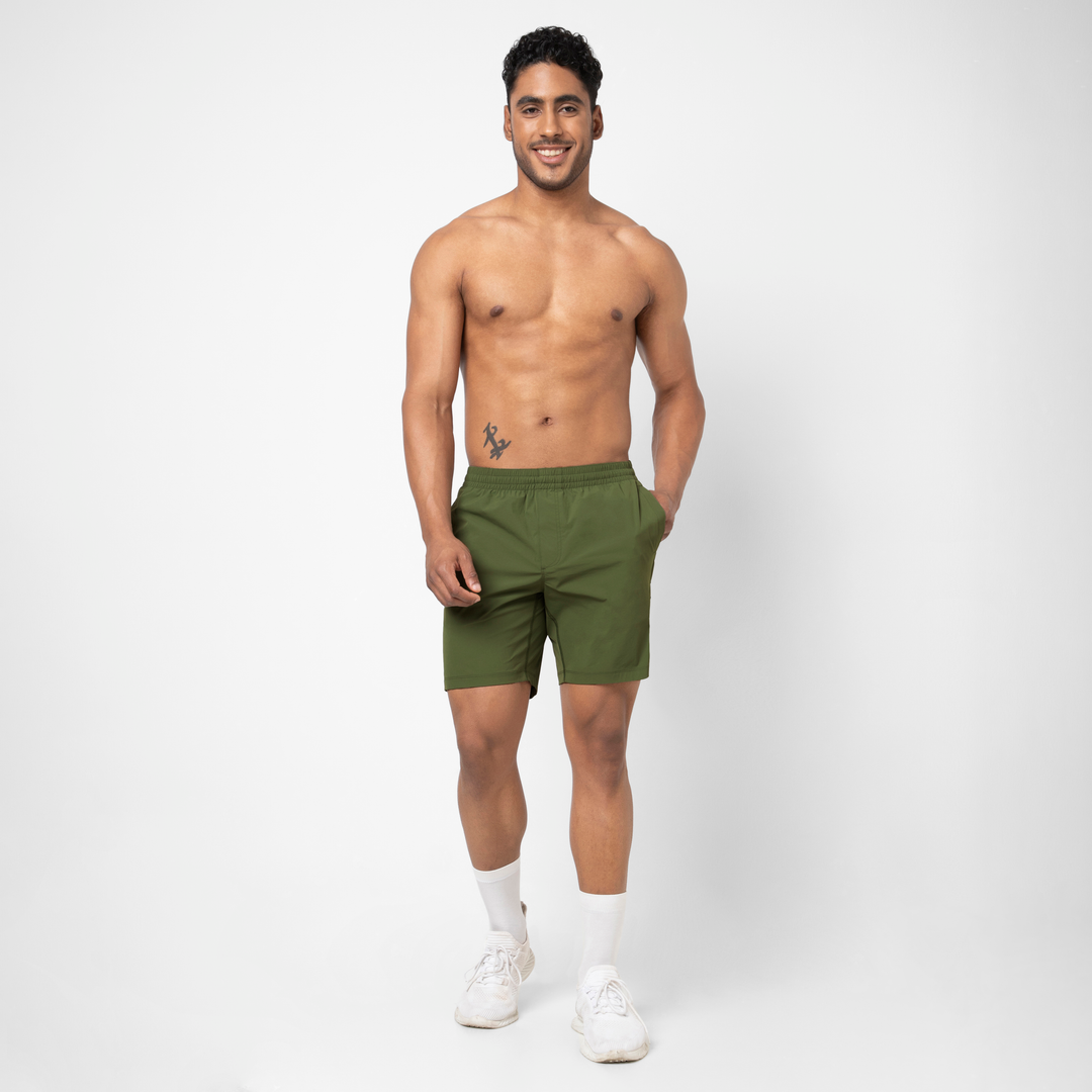 Atlas Short Military Green 7" on model standing with hand in pocket