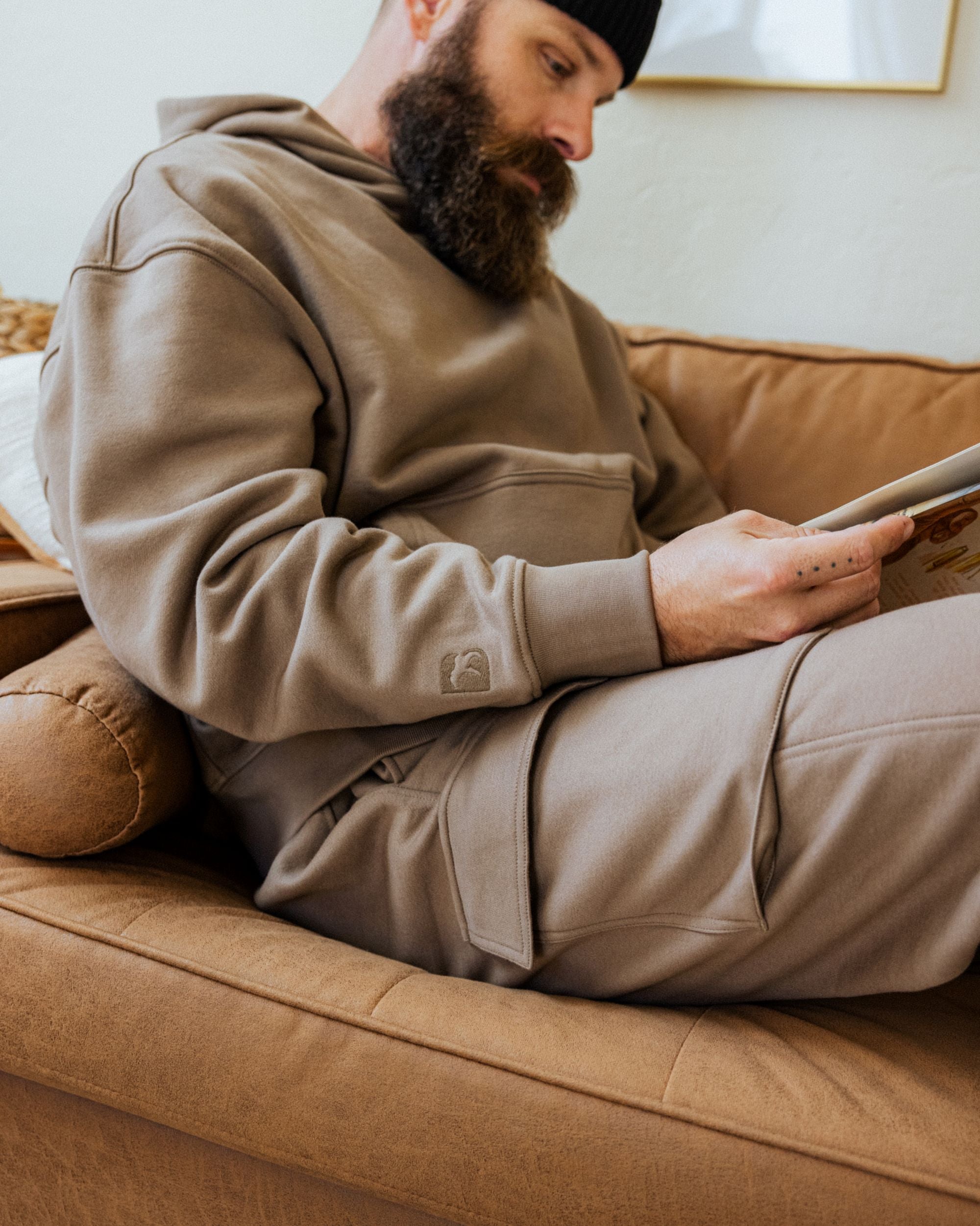 All season staple, core collection. Man wearing Core Hoodie in Driftwood and Core Cargo Pant in Driftwood.