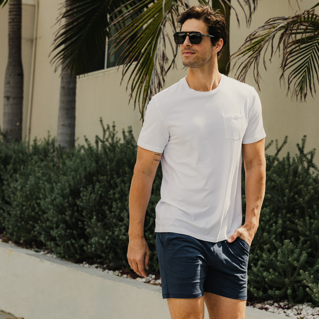 Bamboo Pocket Tee in white on model with lush background