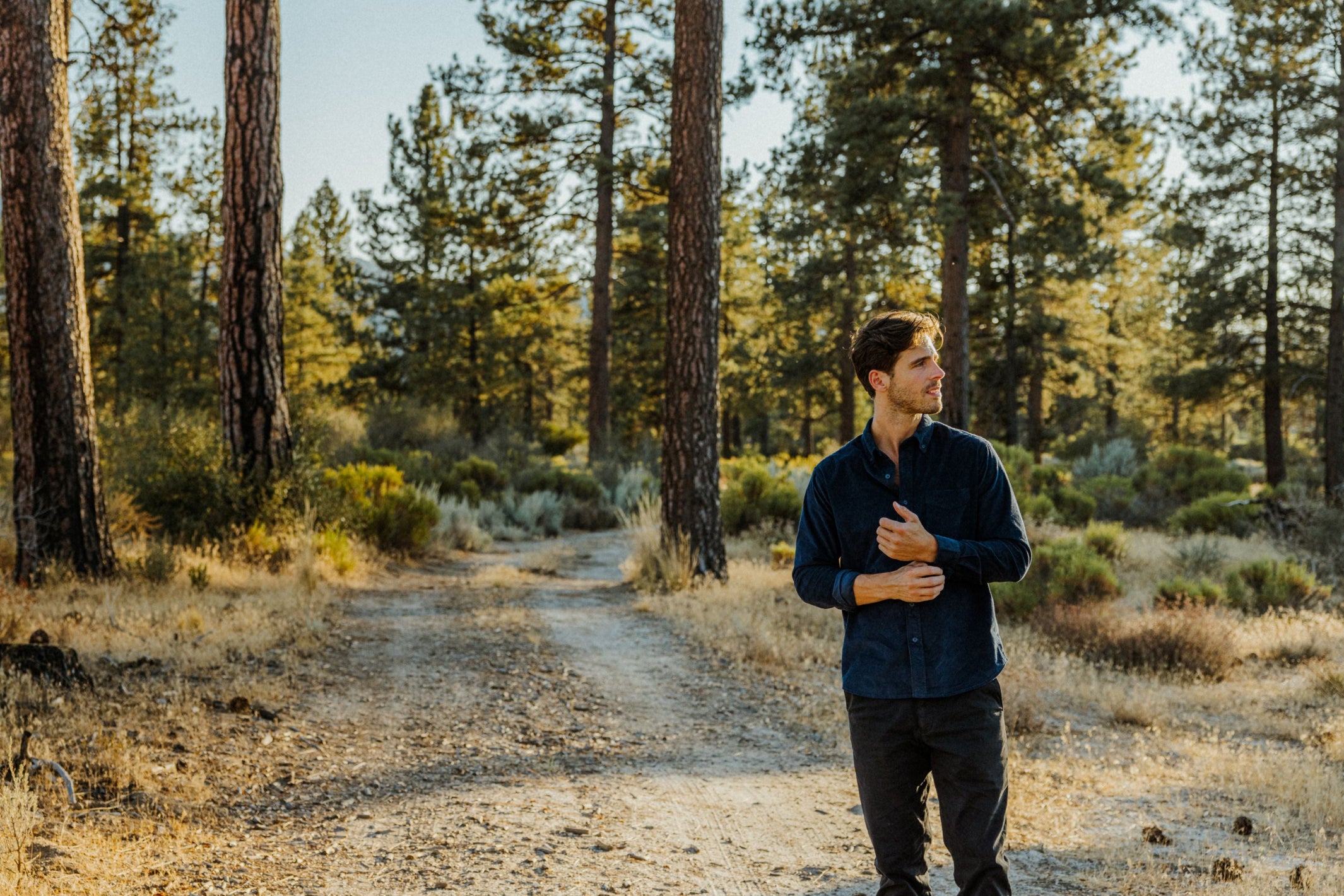 Man wearing Corduroy Workshirt in Navy and Stretch Travel Jean in Charcoal Black