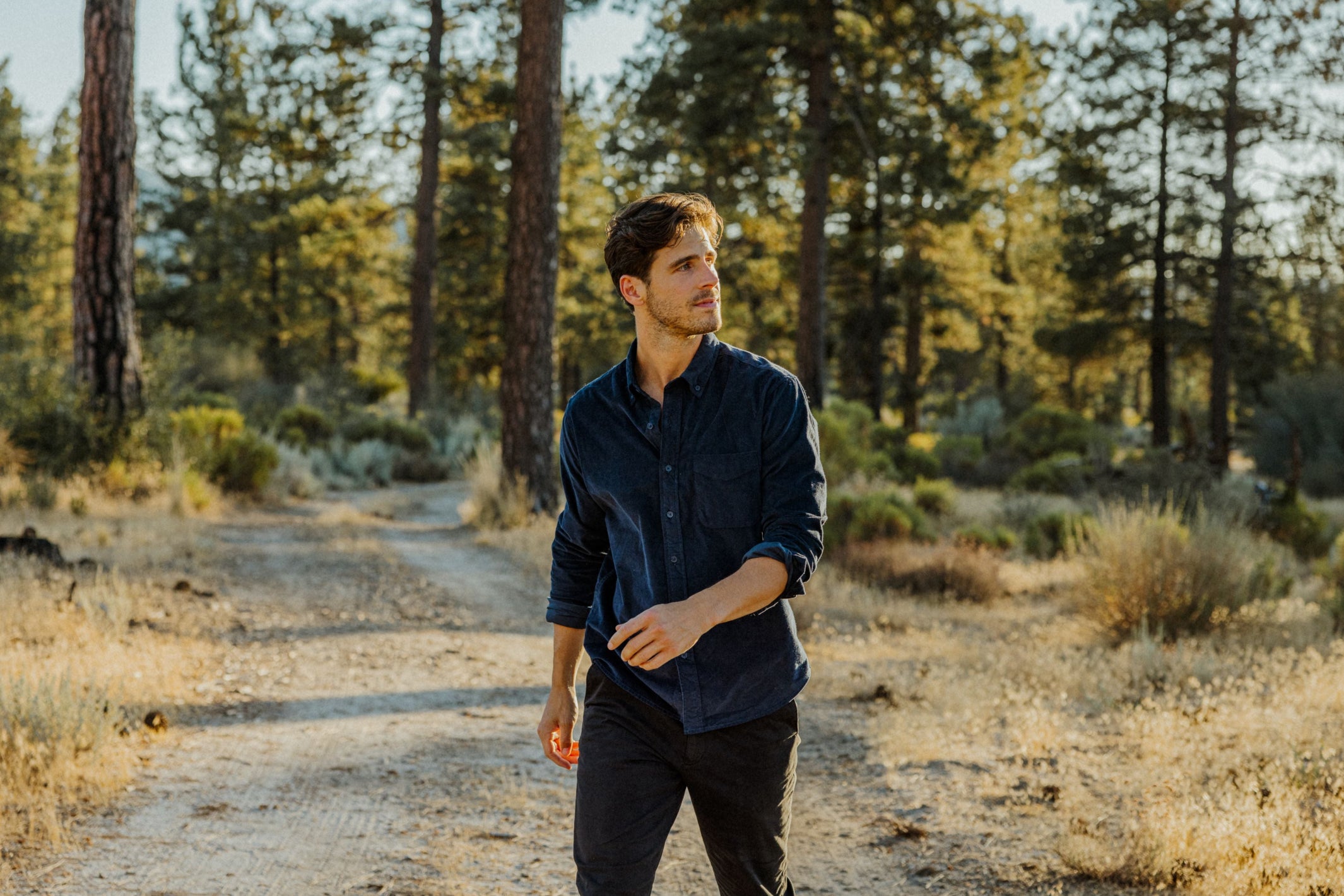 Man wearing Corduroy Workshirt in Navy and Stretch Travel Jean in Charcoal Black