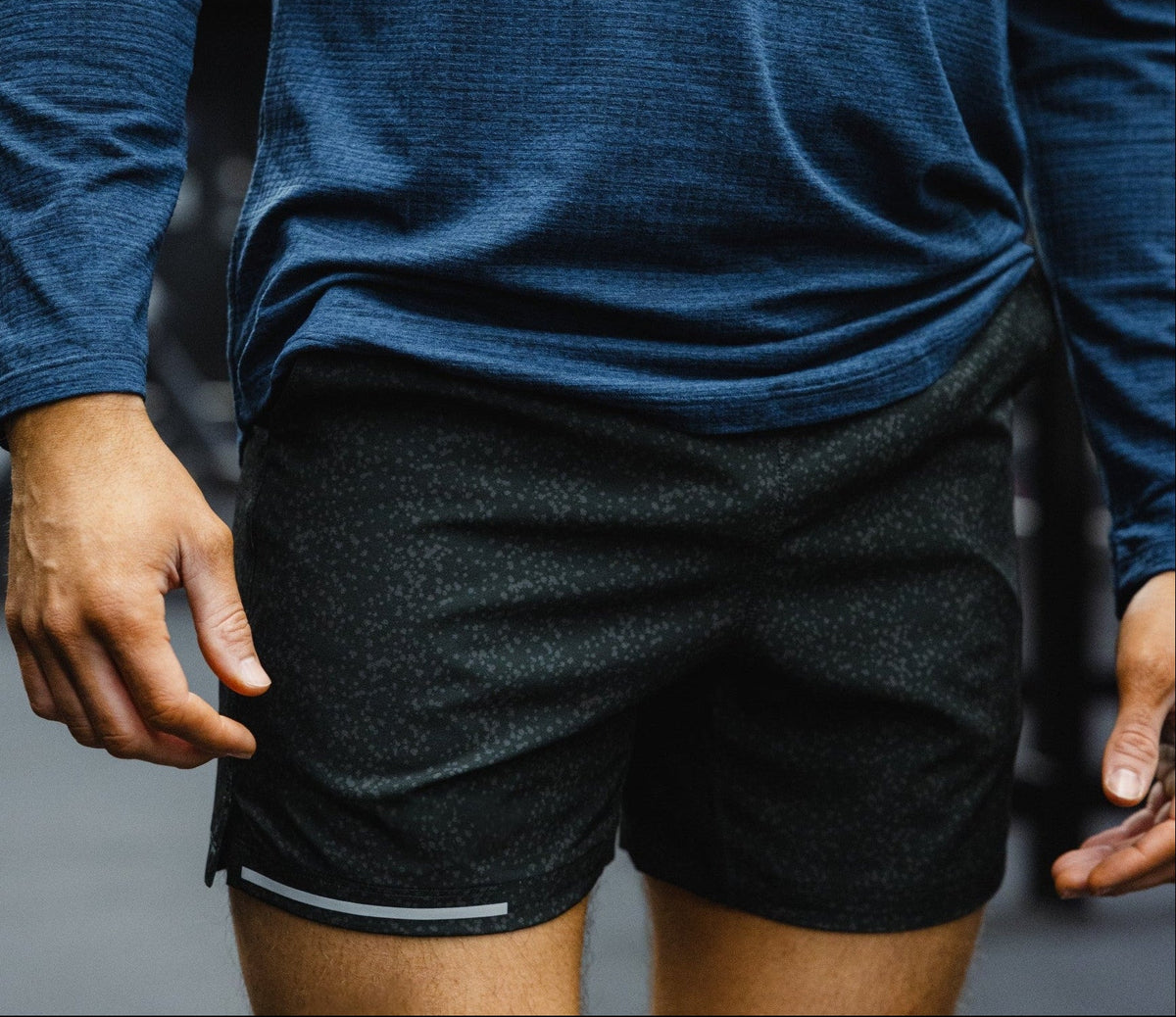 A close-up of a man wearing the Run Short in Sea Salt Black.