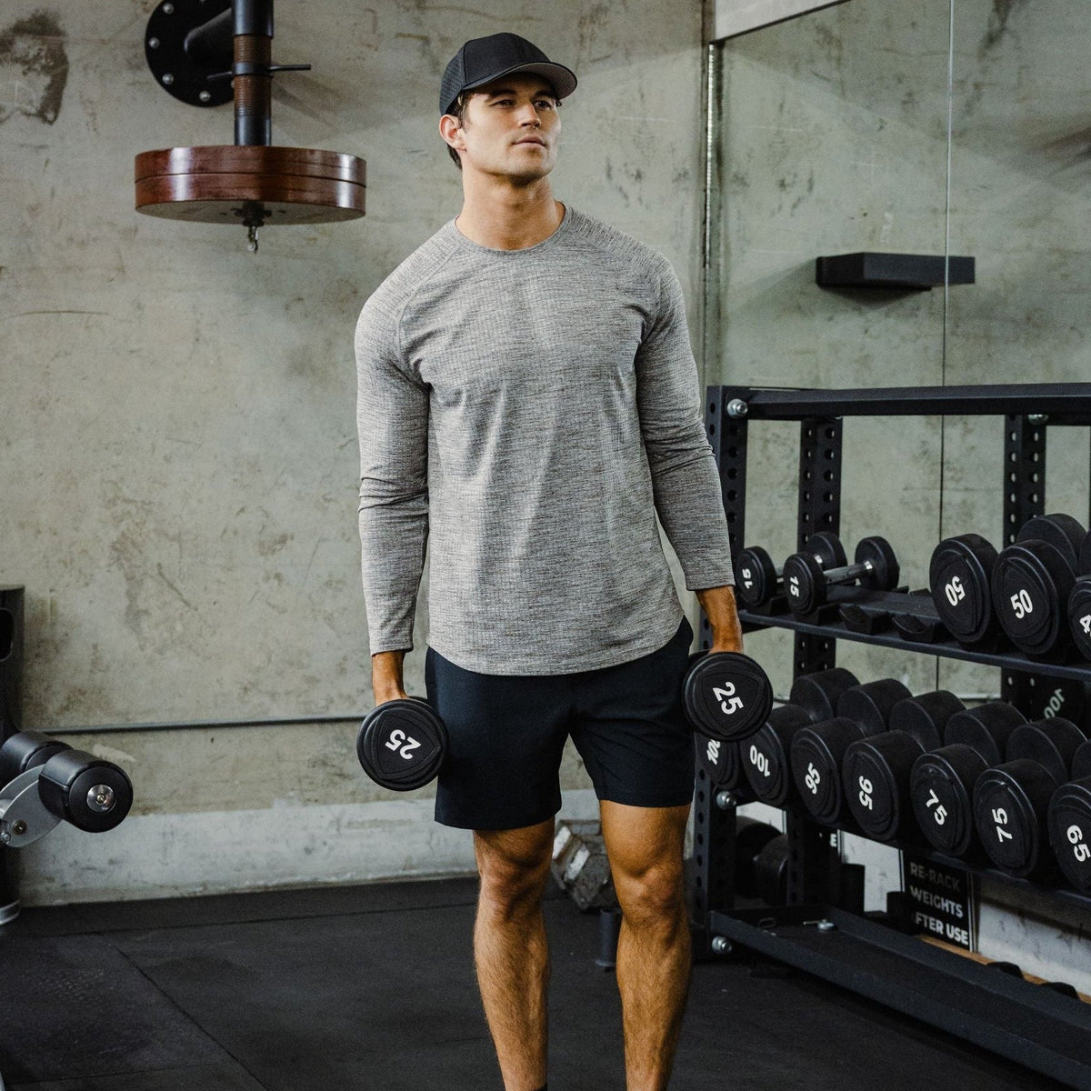 Tread Long Sleeve Tee. Moisture-wicking knit, built for the grind. Man in Tread Long Sleeve tee in Grey and Drifter Short in Black.