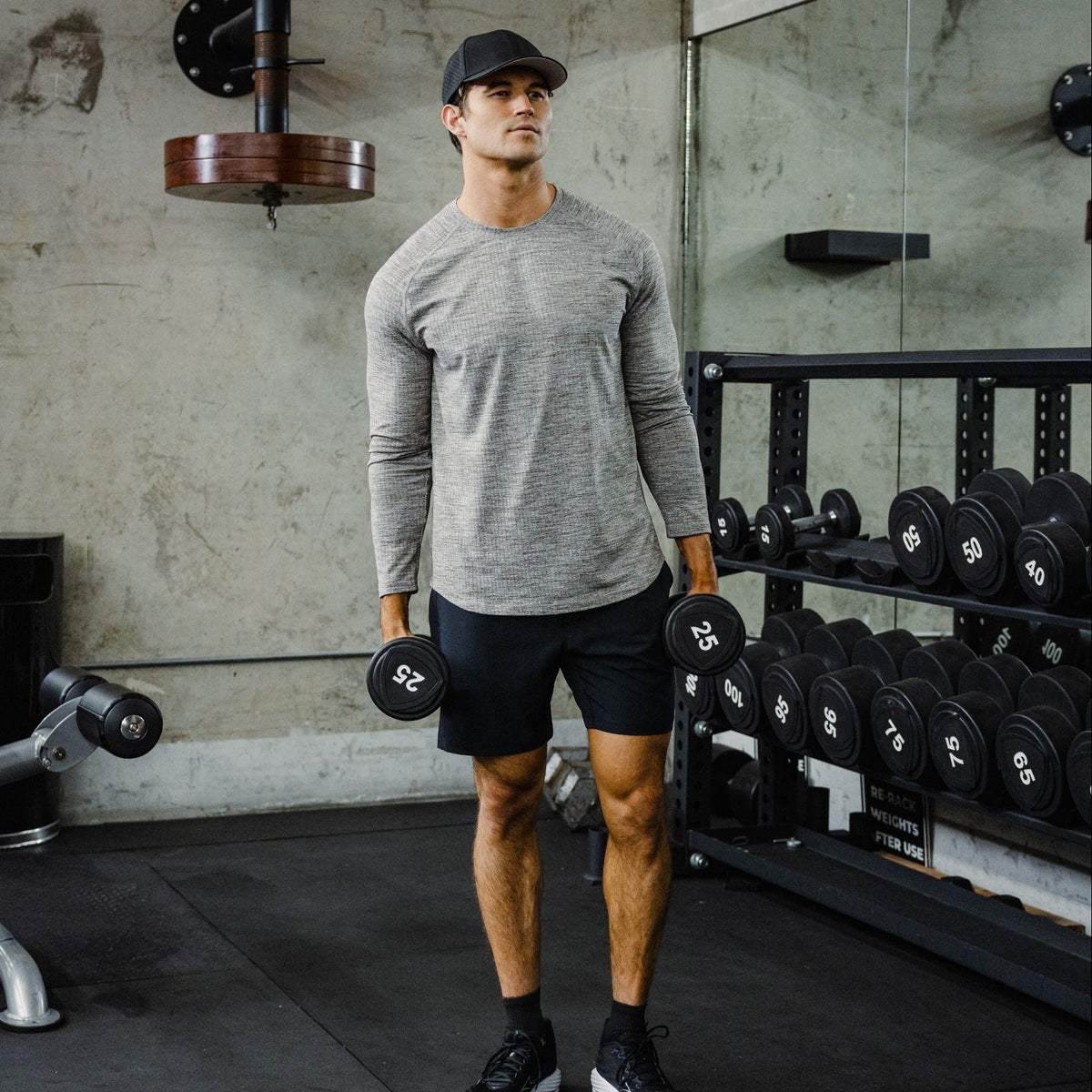 Tread Long Sleeve Tee. Moisture-wicking knit, built for the grind. Man in Tread Long Sleeve tee in Grey and Drifter Short in Black.