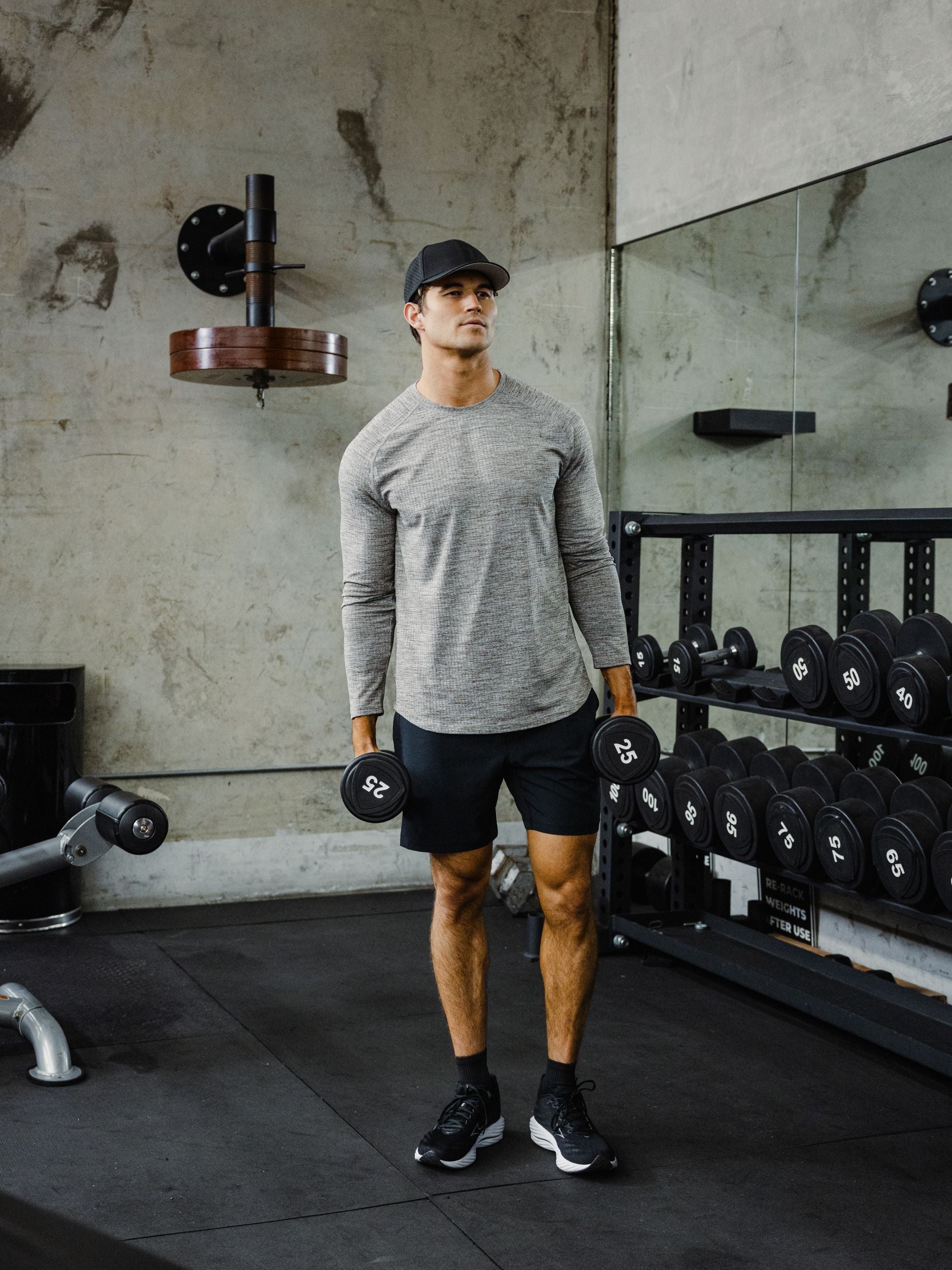 Tread Long Sleeve Tee. Moisture-wicking knit, built for the grind. Man in Tread Long Sleeve tee in Grey and Drifter Short in Black.