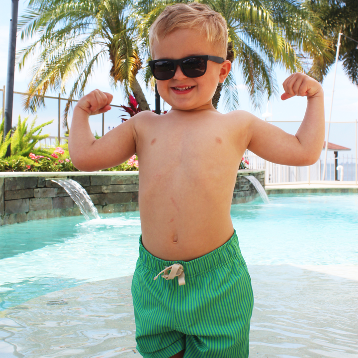 Boys Stretch Swim Gulf Stripe on model flexing arms in pool