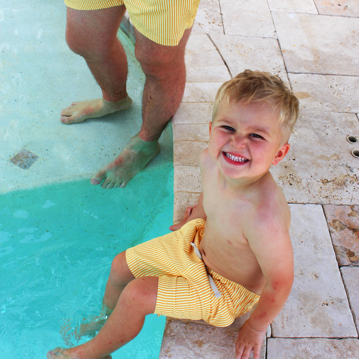 Boys Stretch Swim Sunny Stripe on model sitting by pool