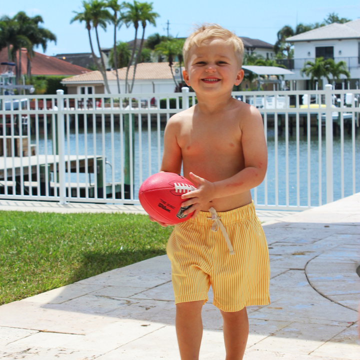 Boys Stretch Swim Sunny Stripe on model carrying football