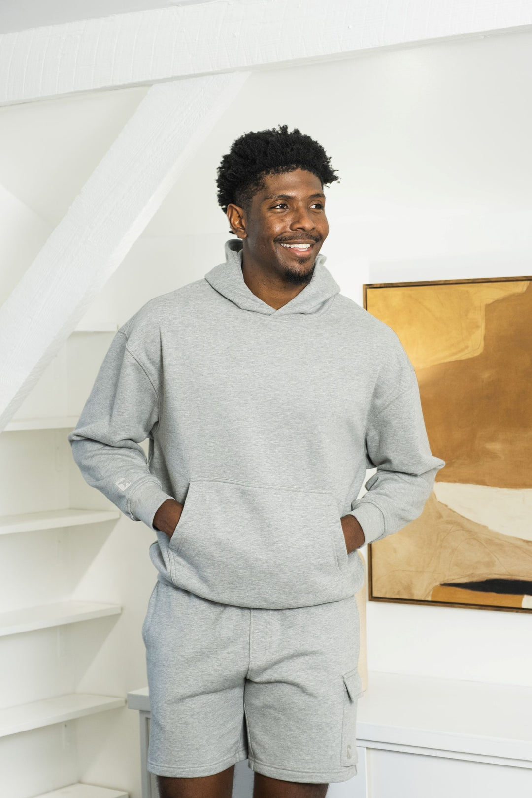 Man in Core Hoodie in Heather Grey and Core Cargo Short in Heather Grey