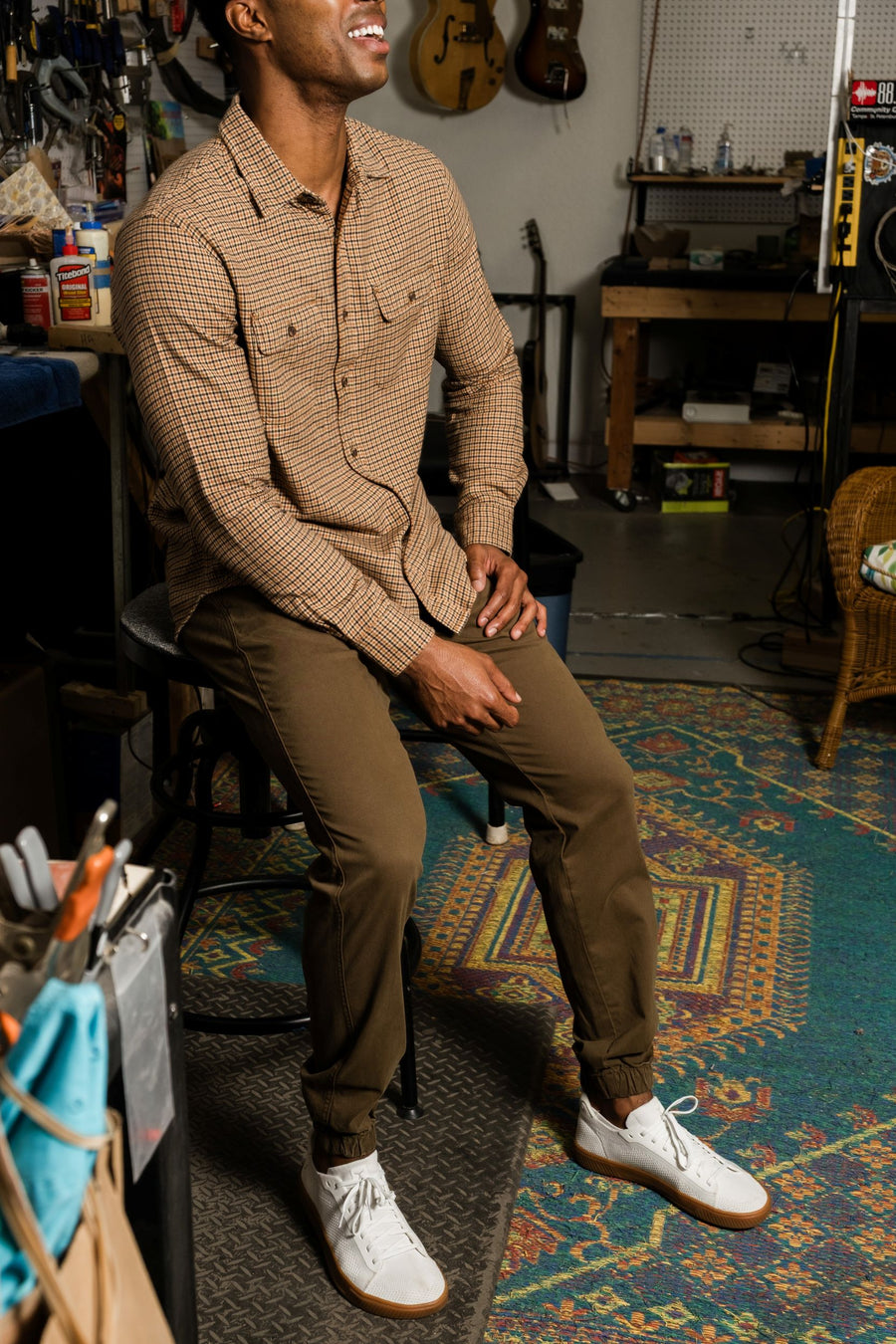 Man sitting on a stool wearing Stretch Jogger in Desert and Everyday Flannel Shirt in Camel/Black in a workshop