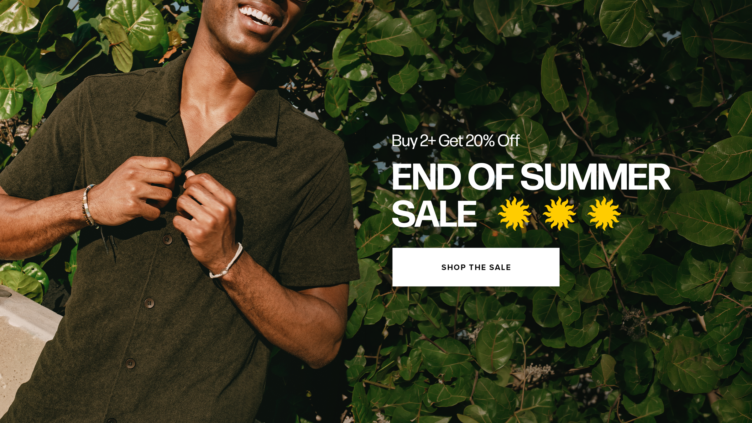 A man wearing a Coastal Terry Shirt  in Dark Pine is shown from the chest up, smiling and adjusting the collar, with dense green foliage in the background. Promotional text on the right reads 'Buy 2+ Get 20% Off END OF SUMMER SALE' with three yellow sun icons and a 'SHOP THE SALE' button.