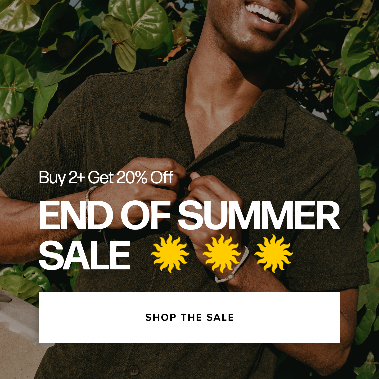 A man wearing a Coastal Terry Shirt  in Dark Pine is shown from the chest up, smiling and adjusting the collar, with dense green foliage in the background. Promotional text on the right reads 'Buy 2+ Get 20% Off END OF SUMMER SALE' with three yellow sun icons and a 'SHOP THE SALE' button.