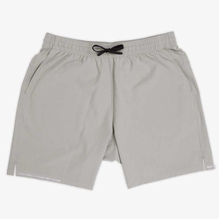 Run Short v2 7" Grey front with elastic waistband, dyed-to-match drawstring with rubberized tips, two front pockets, split hem, and reflective line on bottom right hem