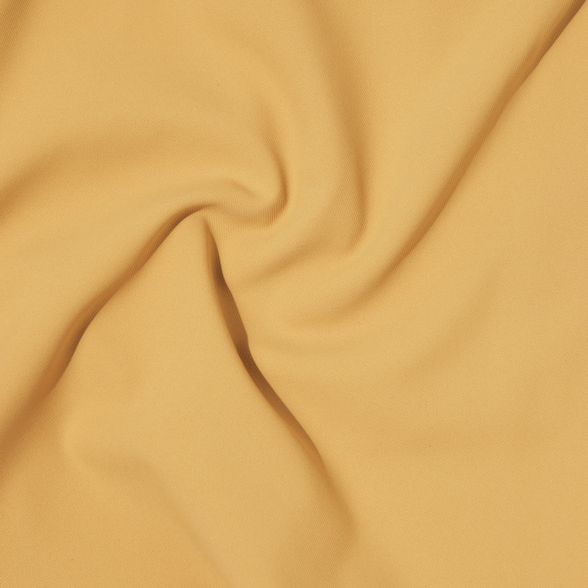 A close-up of the Hybrid Short’s light yellow fabric with gentle folds and soft shadows, highlighting its smooth texture and subtle 4-way stretch for comfortable, travel-ready performance.