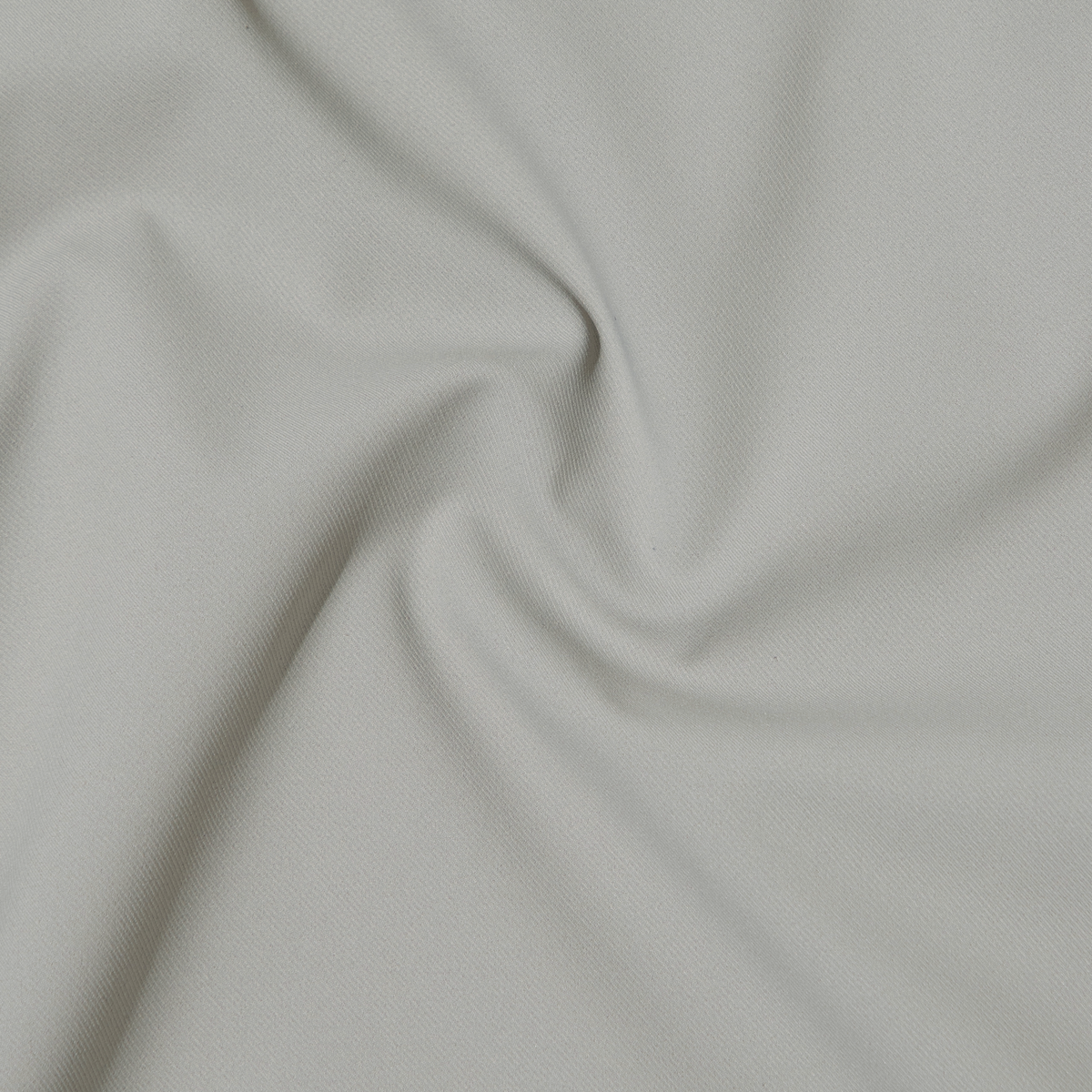 The Hybrid Short features light gray fabric with a soft, smooth feel and 4-way stretch, gently twisted to form subtle center folds—ideal for travel-ready performance.