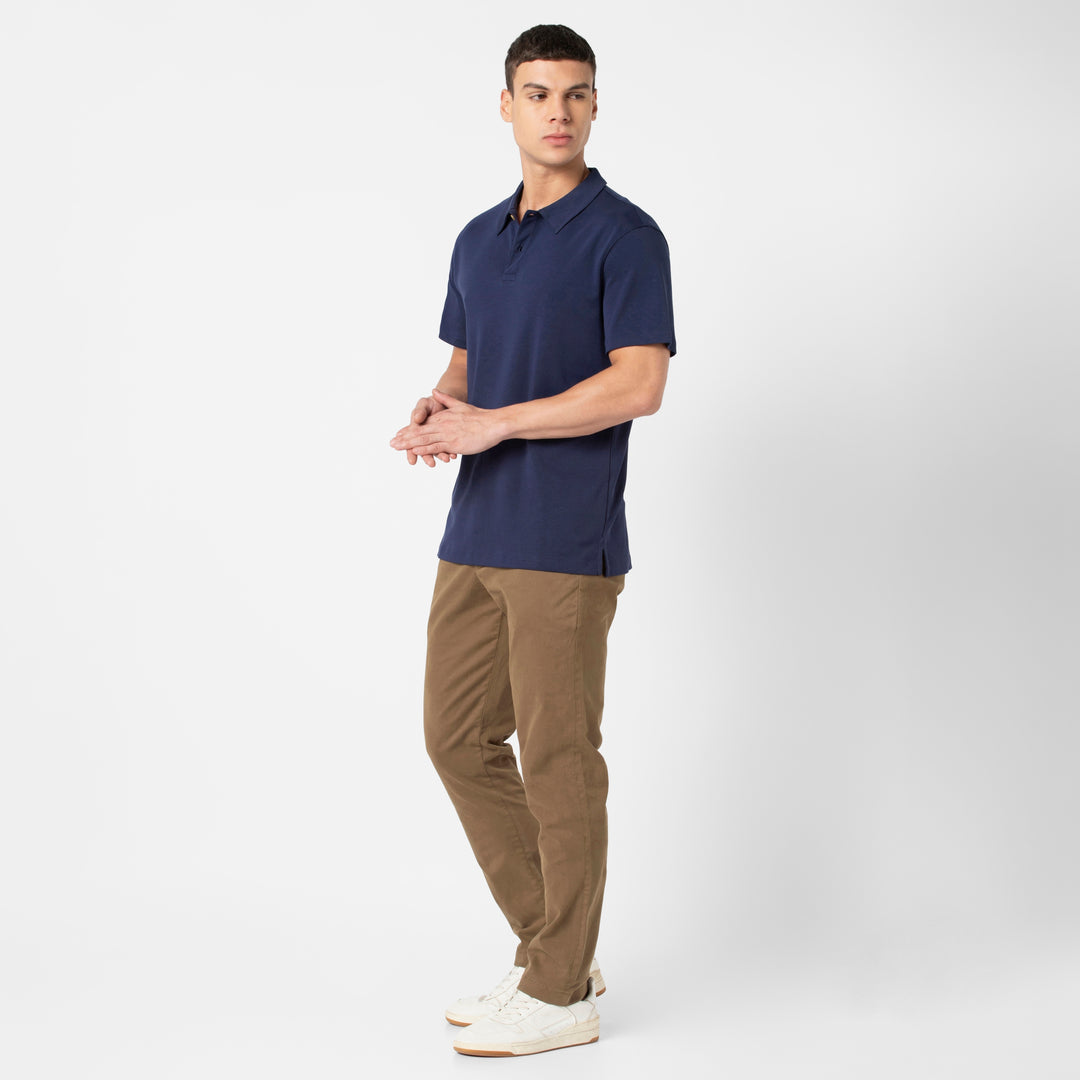 Midweight Supima Polo Navy standing wearing Stretch Chino Pant Desert on model
