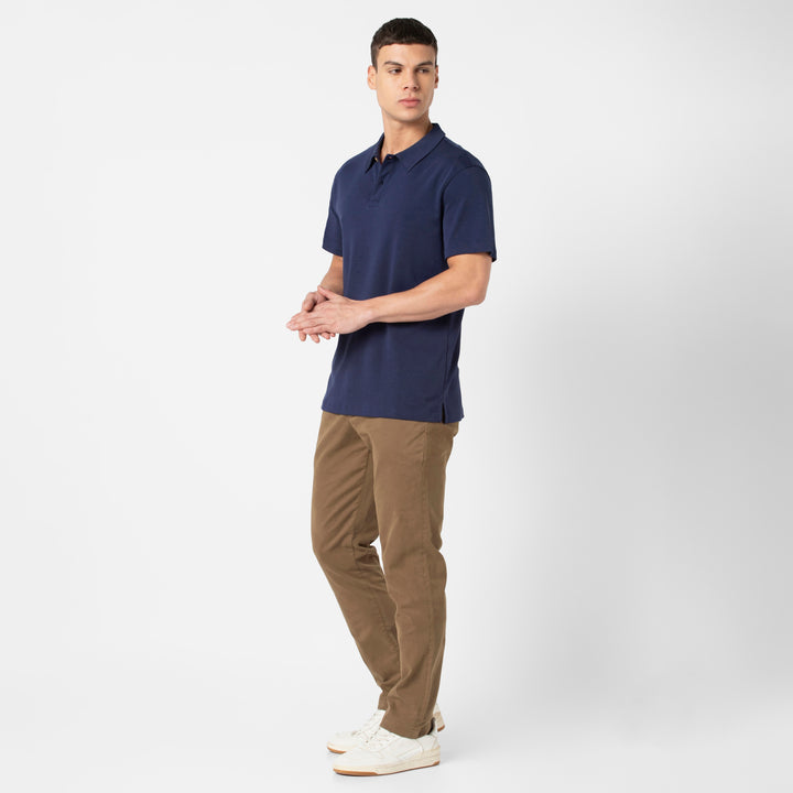 Midweight Supima Polo Navy standing wearing Stretch Chino Pant Desert on model