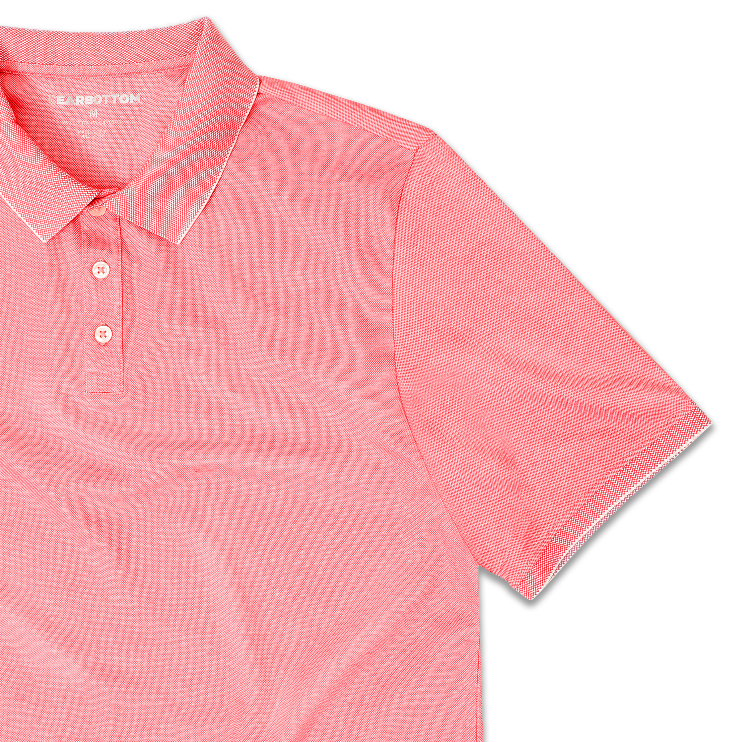 Range Polo Coral front close up with ribbed collar, ribbed short sleeves, and 3 white buttons