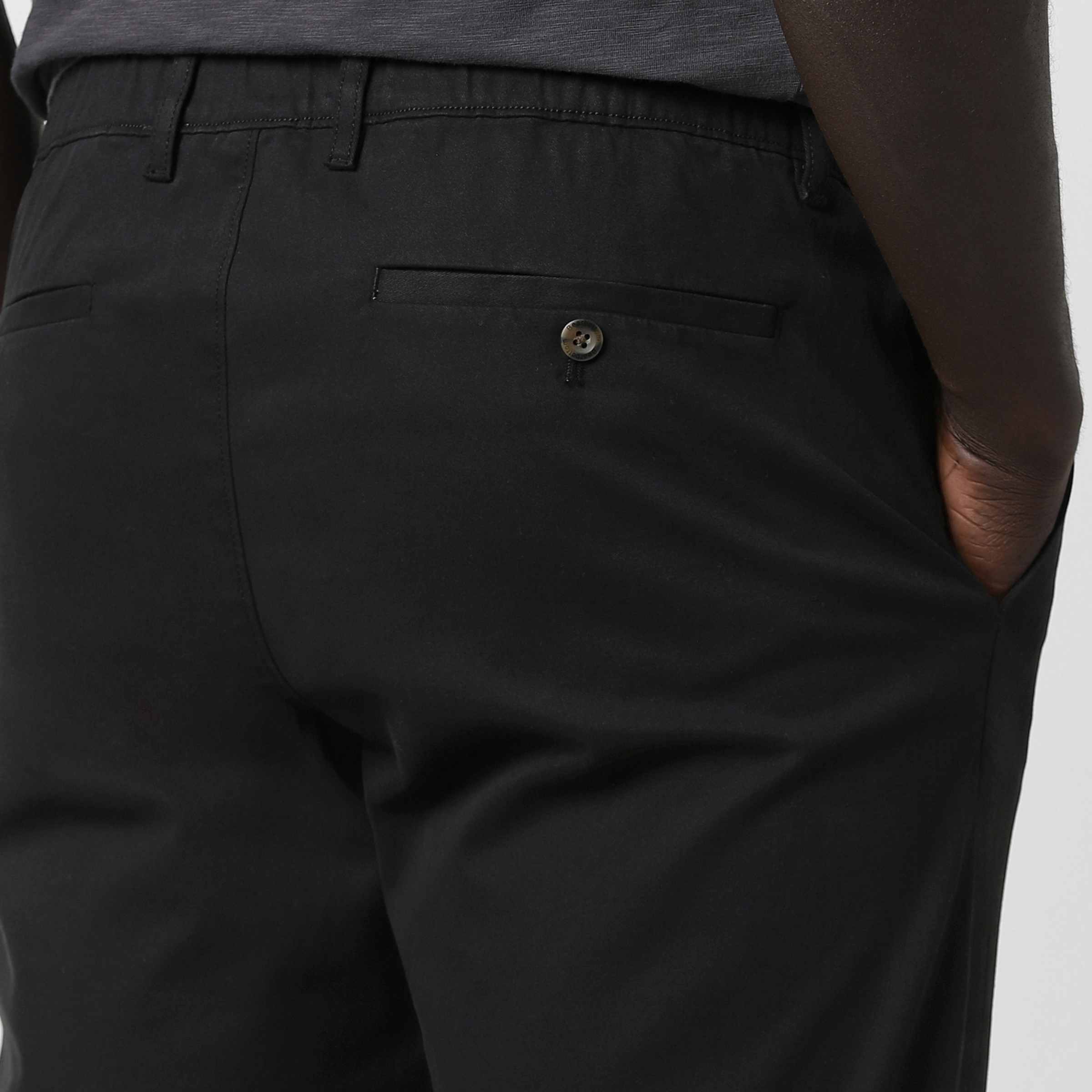 Relaxed Stretch Chino Pant Black close up back right pocket on model