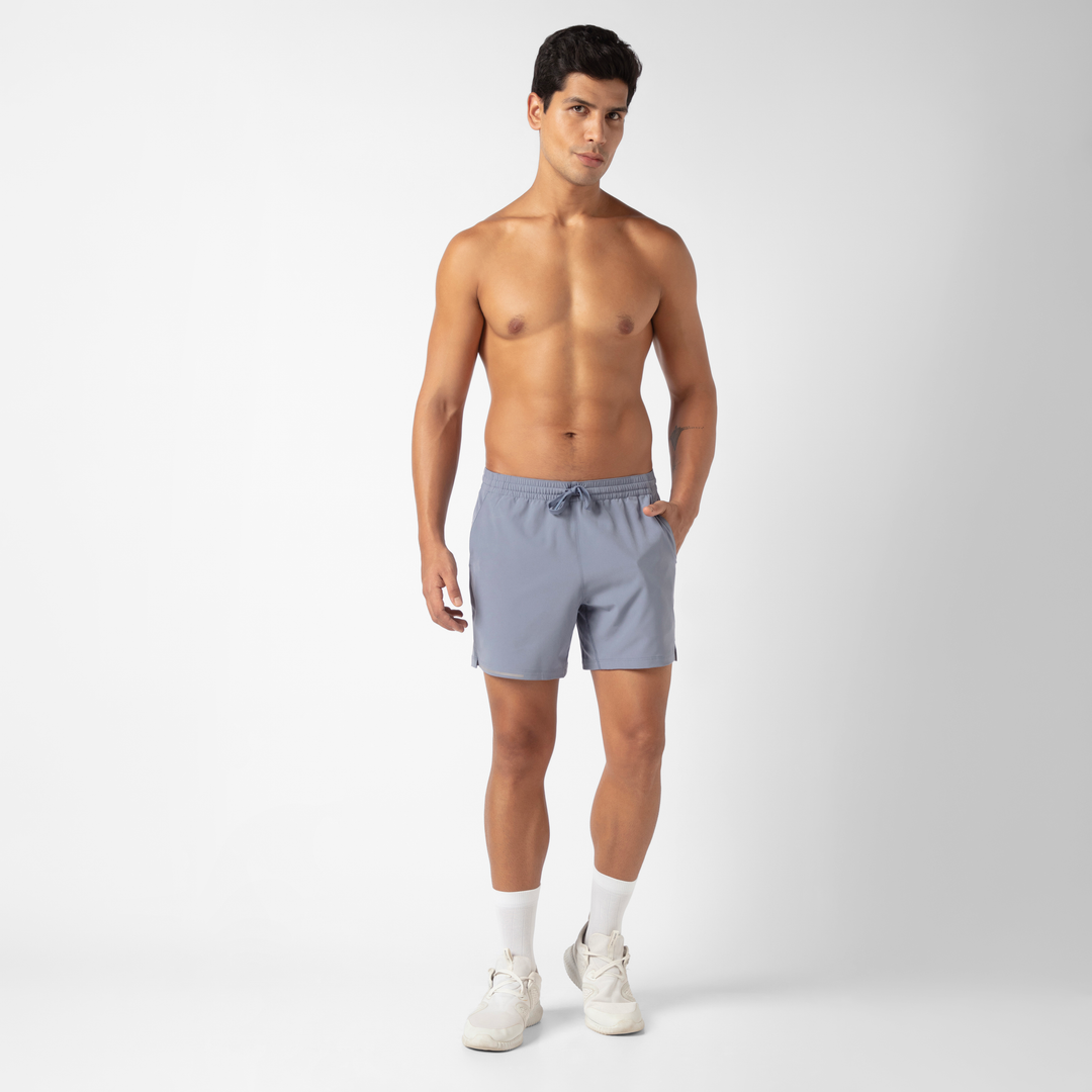 Run Short v2 5.5" Flint on model standing with hand in side seam pocket