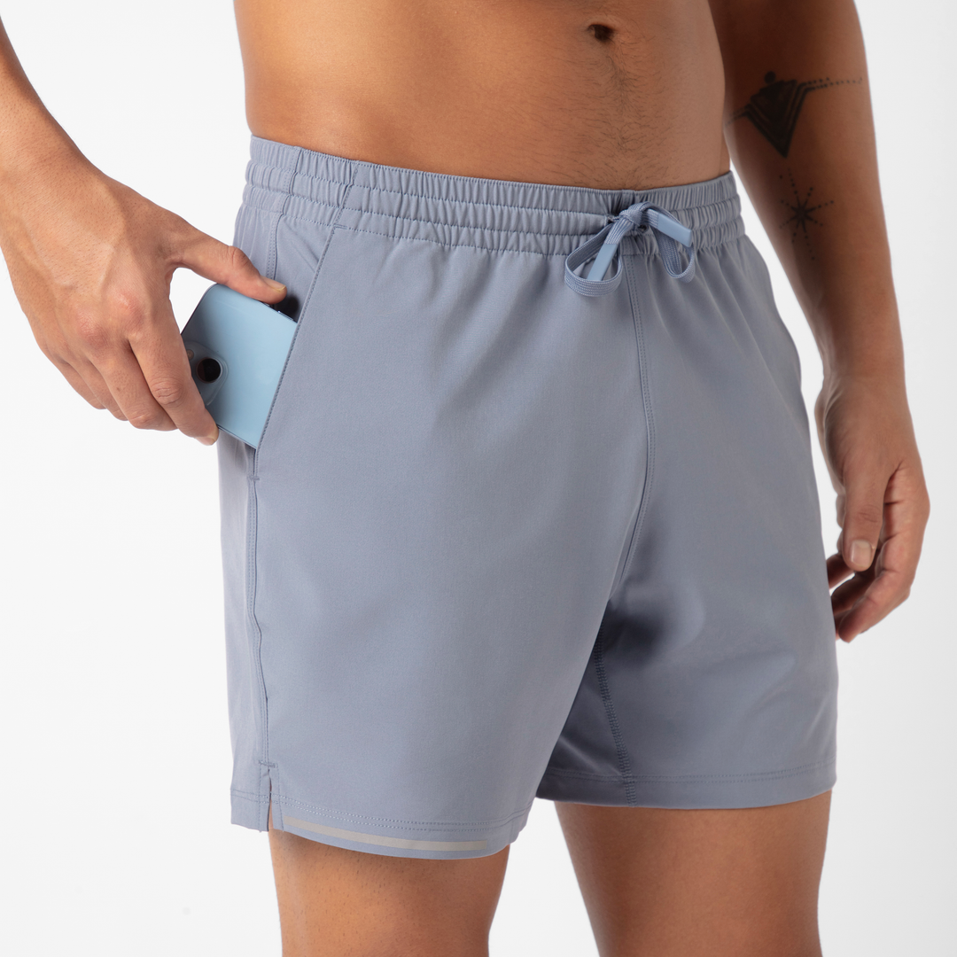 Run Short v2 5.5" Flint front close up of phone stability pocket on model