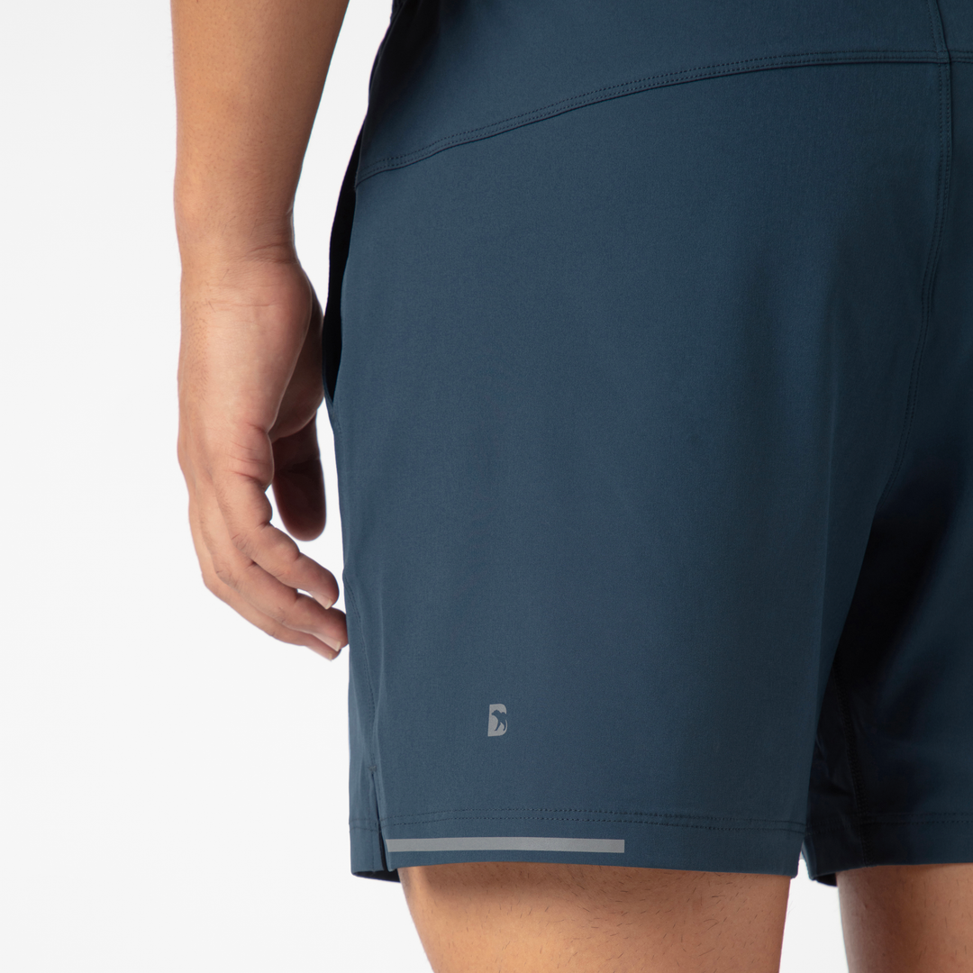 Run Short v2 5.5" Navy back close up of left leg with reflective B logo and reflective strip on hem on model 