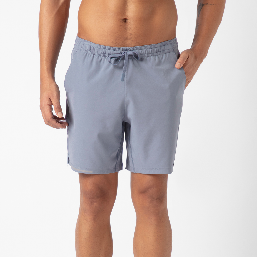 Run Short v2 7" in Flint front on model with hand in side seam pocket