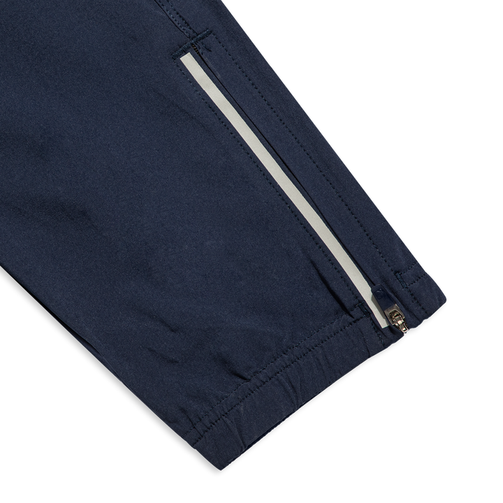 Run Jogger Navy close up zipper at ankles, and reflective strip at side seam/bottom hem