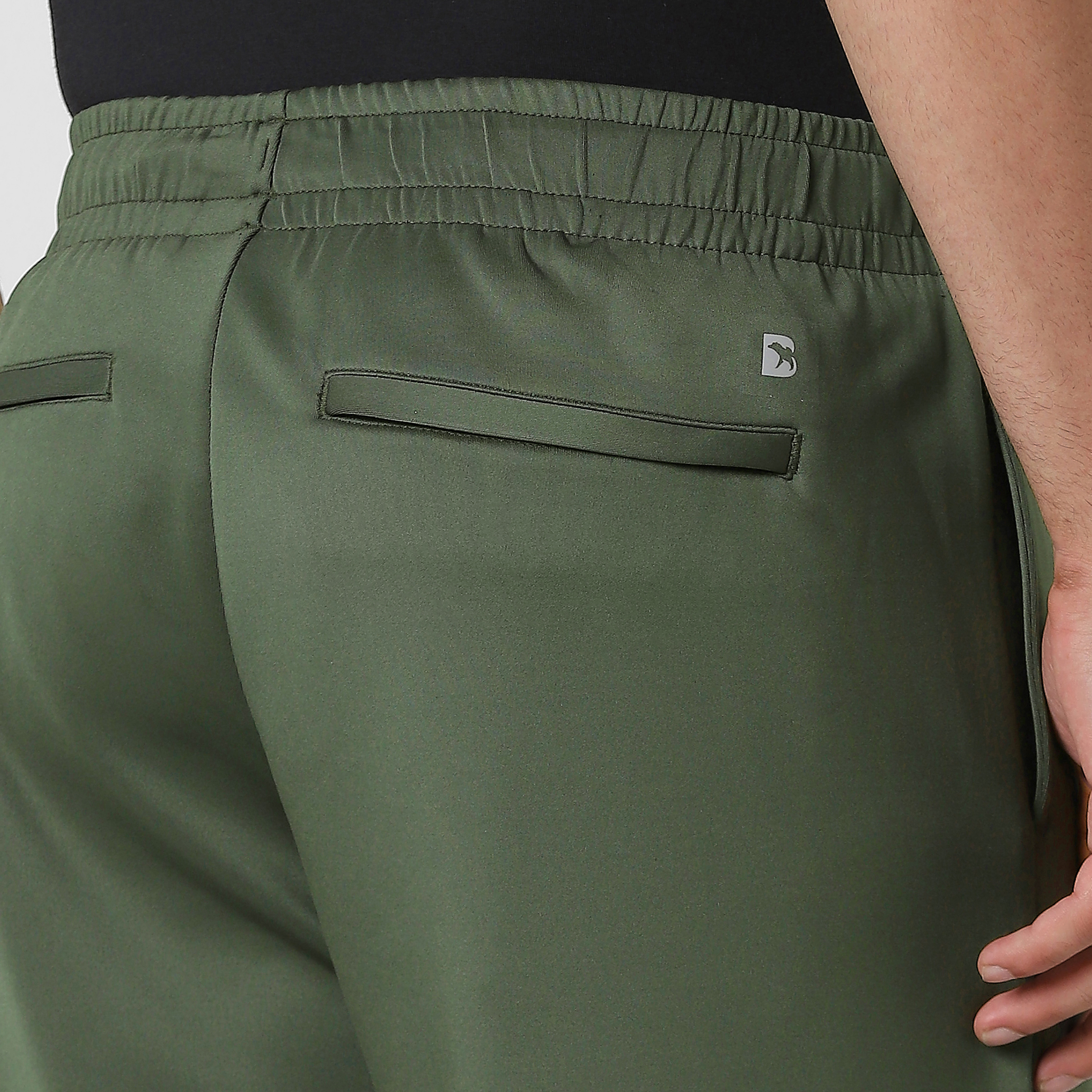 Scuba Jogger Military Green close up back zipper pockets on model