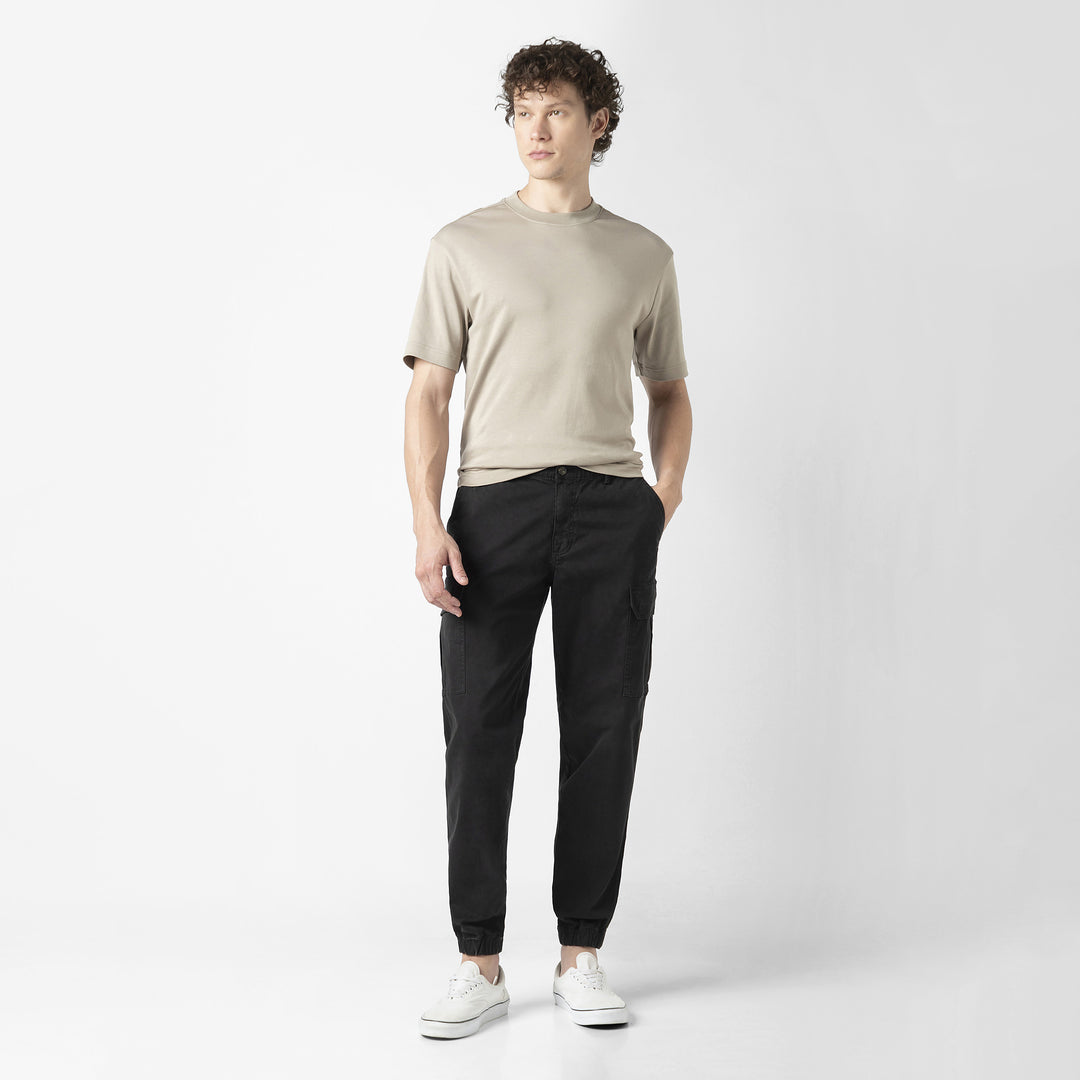 Model front facing wearing Stretch Cargo Joggers in Black