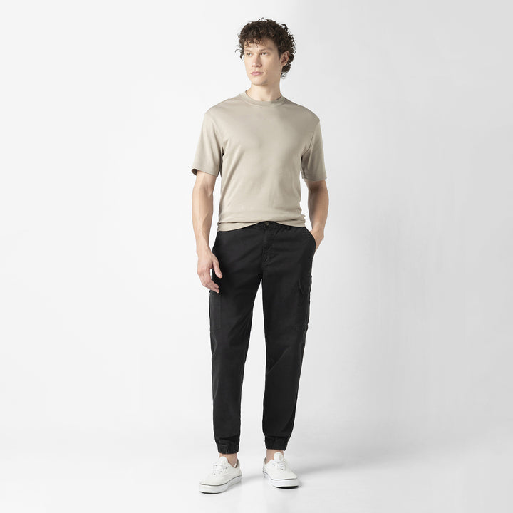 Model front facing wearing Stretch Cargo Joggers in Black