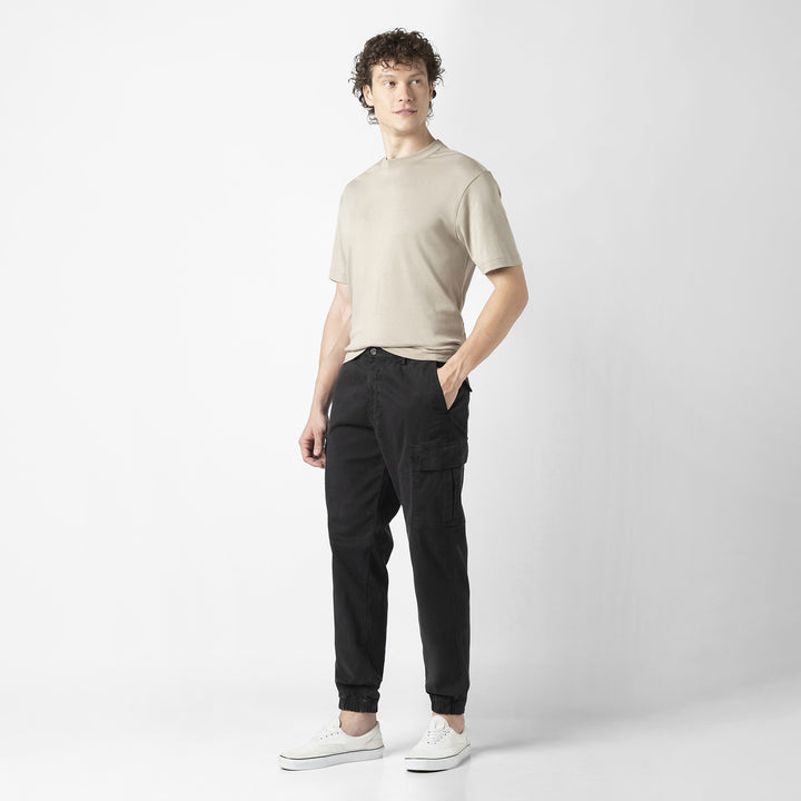 Model front facing wearing Stretch Cargo Joggers in Black