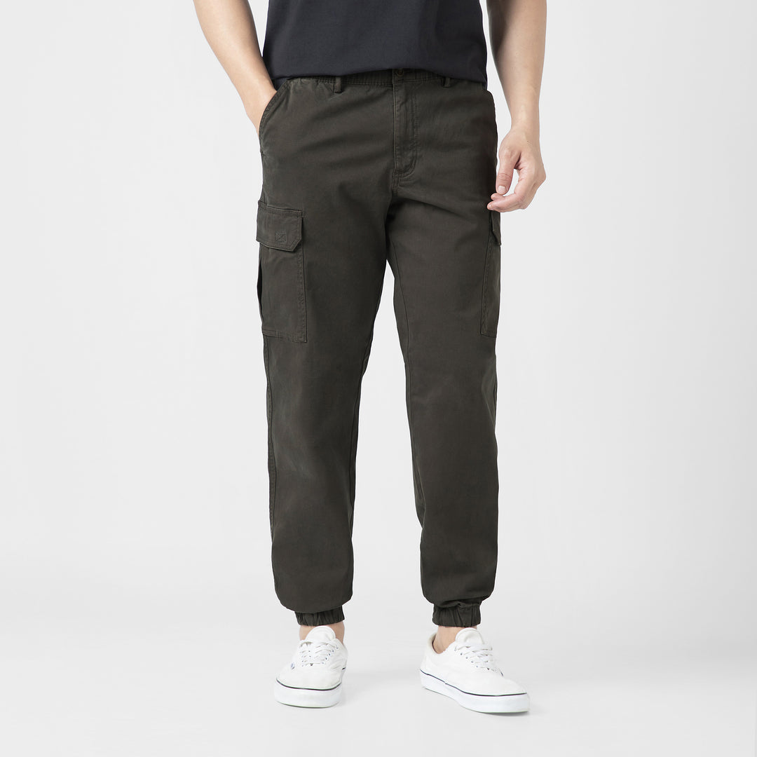 Model front facing wearing Stretch Cargo Joggers in Dark Grey