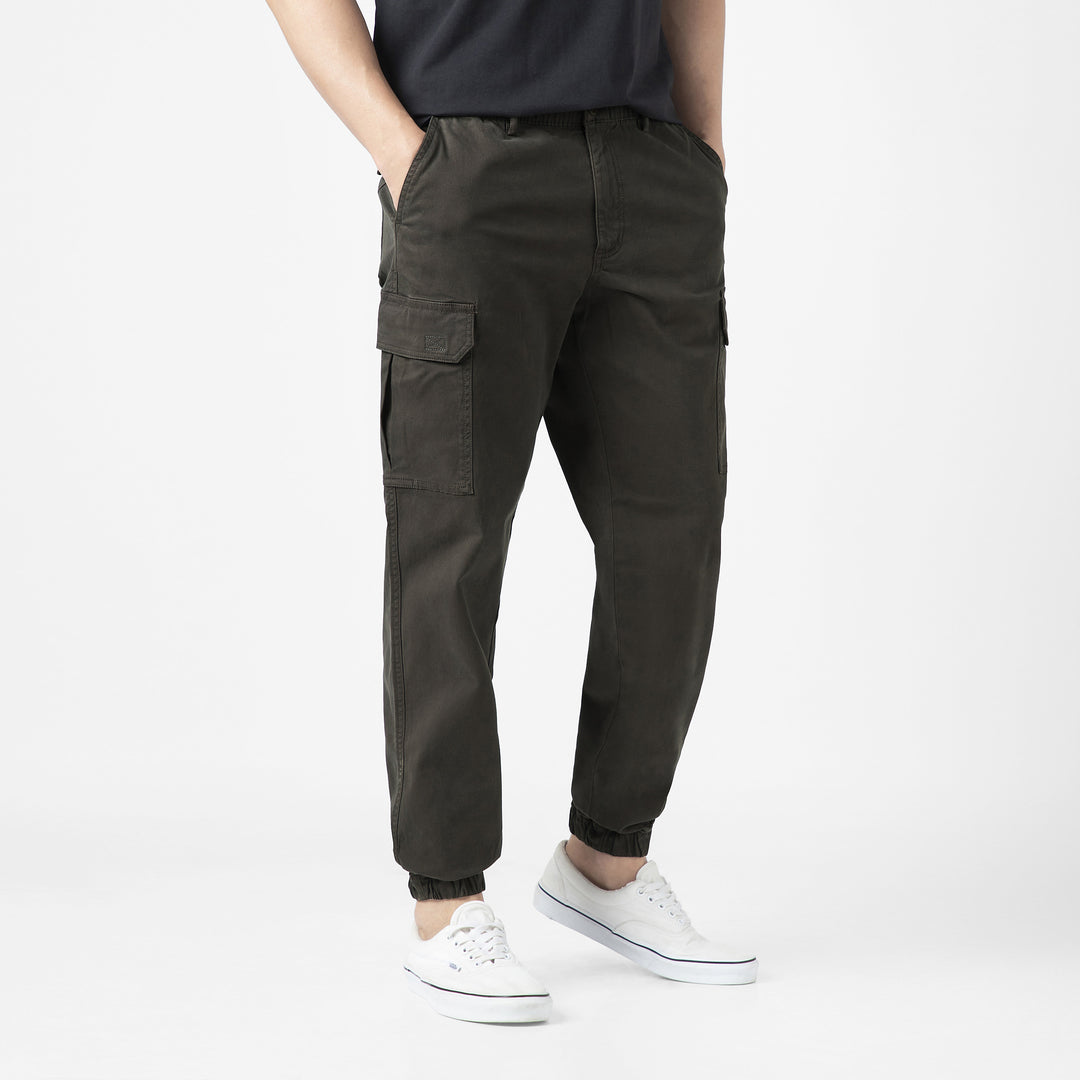 Model front facing wearing Stretch Cargo Joggers in Dark Grey