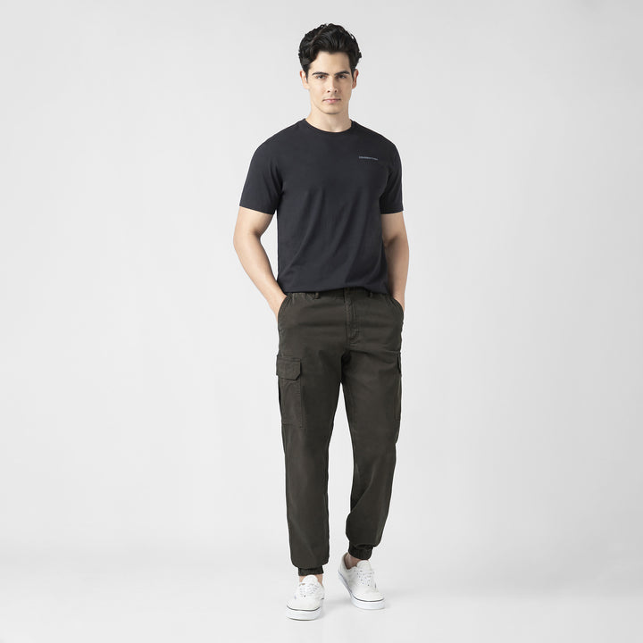 Model front facing wearing Stretch Cargo Joggers in Dark Grey