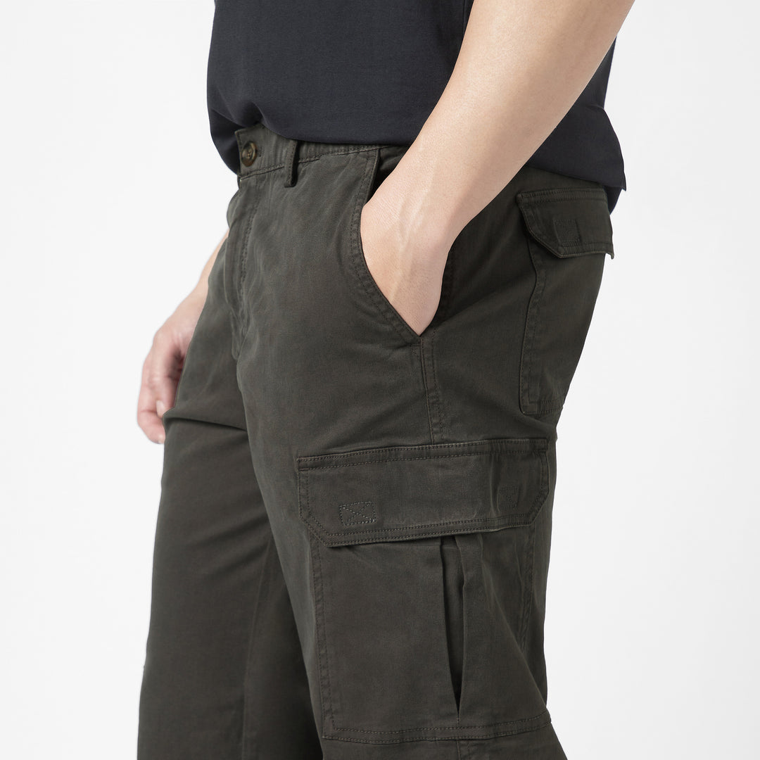 Model side facing wearing Stretch Cargo Joggers in Dark Grey