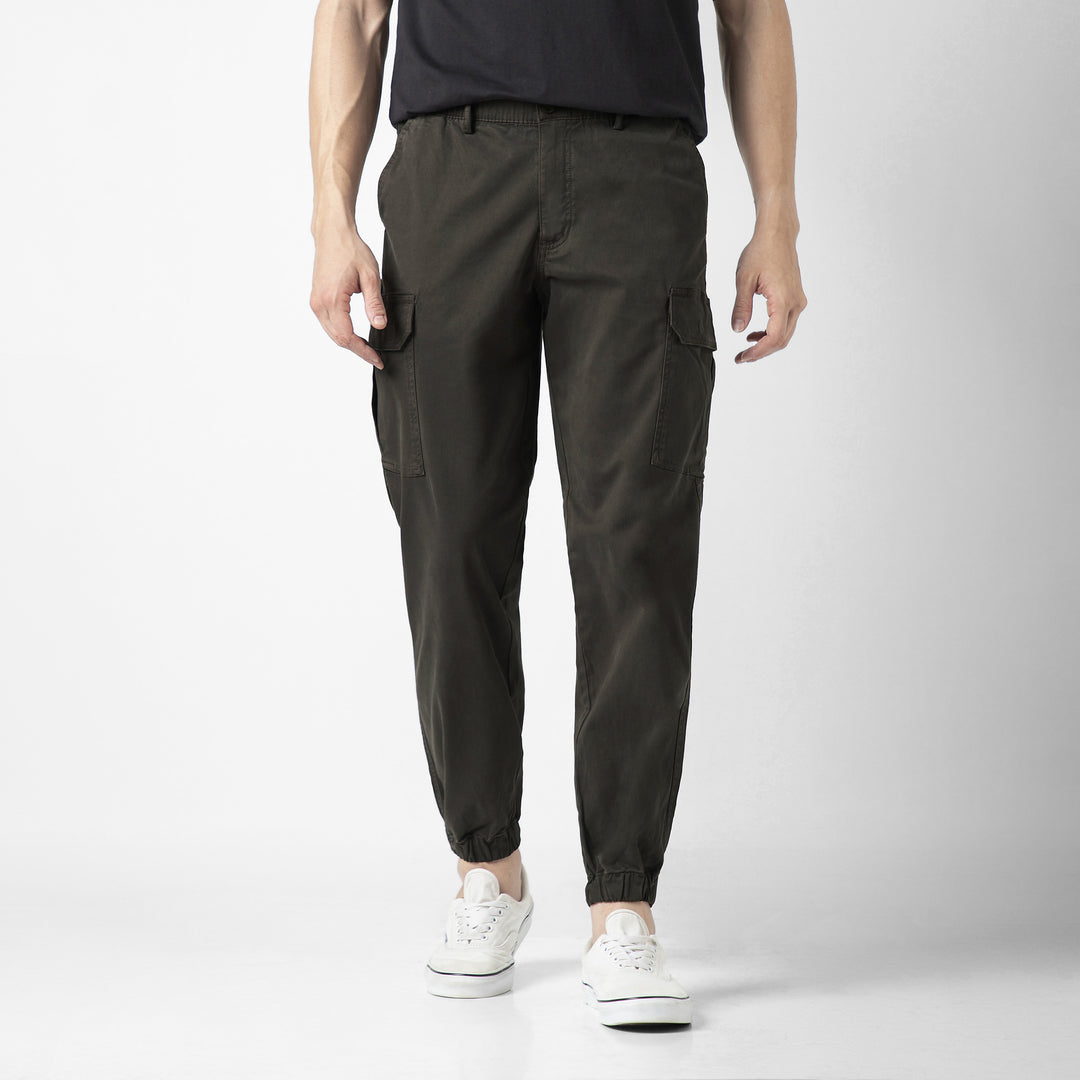 Model front facing wearing Stretch Cargo Joggers in Dark Grey