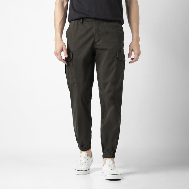 Model front facing wearing Stretch Cargo Joggers in Dark Grey