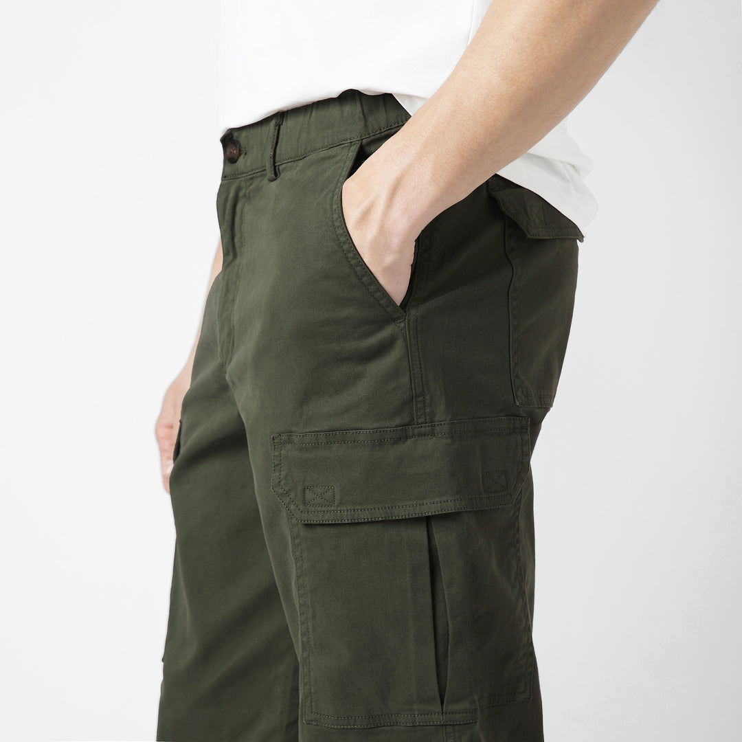 Model side facing wearing Stretch Cargo Joggers in Military Green
