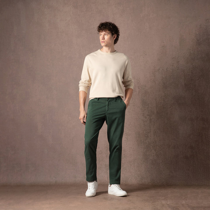 Stretch Chino Pant Dark Sage full body on model with backdrop