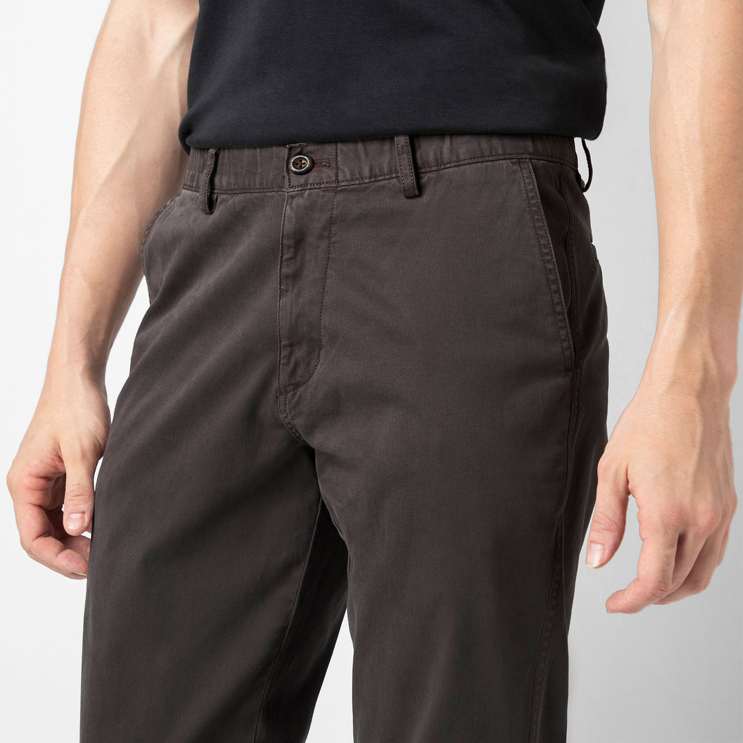 A close up of the Coal Stretch Jogger showing the premium cotton fabric, button closure, belt loops and slanted side pockets at the waist.