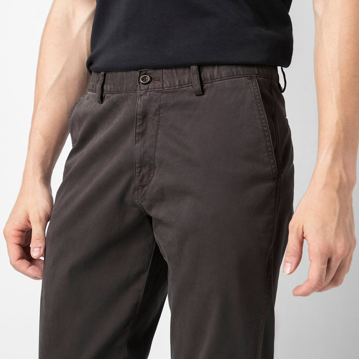 A close up of the Coal Stretch Jogger showing the premium cotton fabric, button closure, belt loops and slanted side pockets at the waist.
