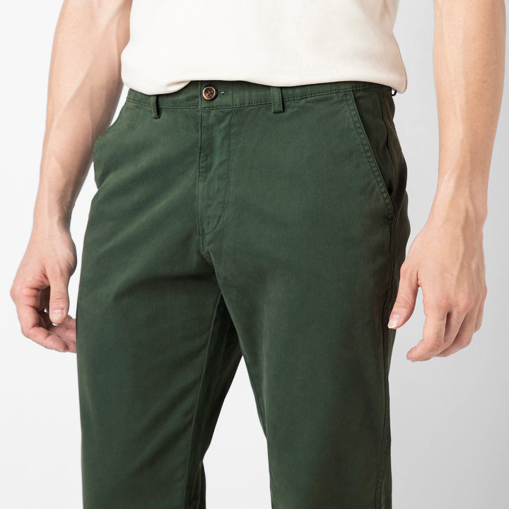 A close up of the Dark Sage Stretch Jogger showing the premium cotton fabric, button closure, belt loops and slanted side pockets at the waist.